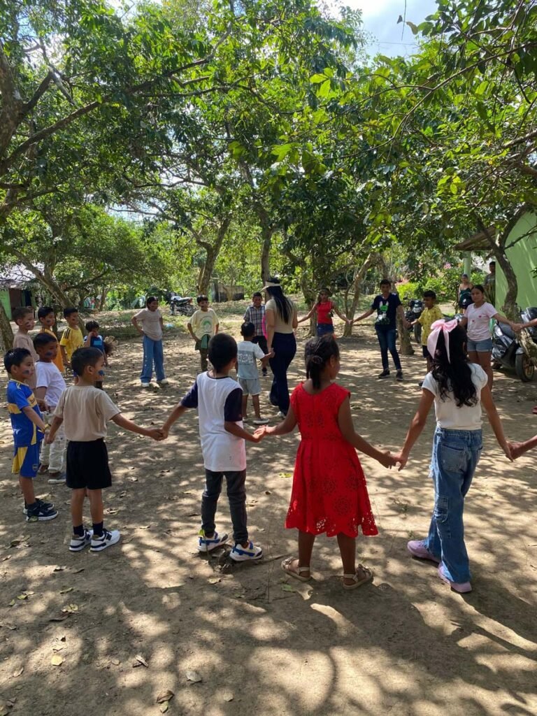 estudiantes jugando y celbrando la entrega de sus kits escolares